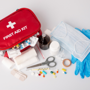 Safety essentials including first aid kit, reflective vest, flashlight, and tire repair tools for a long motorcycle trip